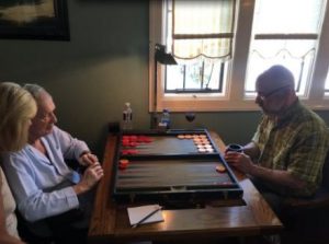 David Hefner's sister, dad, and brother, playing Backgammon