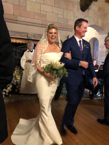 Ashleigh Walters in a wedding dress with her husband