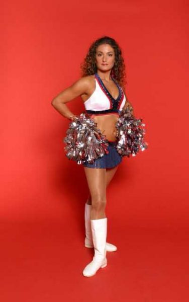 Lara Travis posing in her cheerleading costume