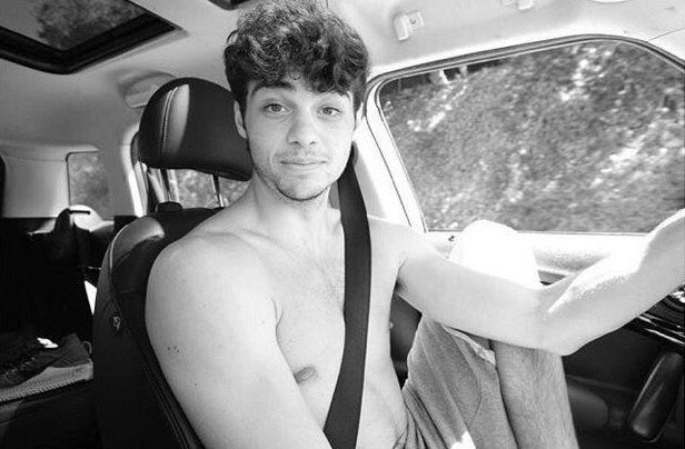Taylor Centineo's brother Noah sitting inside his car t-shirtless