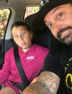 Cody Herpin with his daughter, Zoie on his car