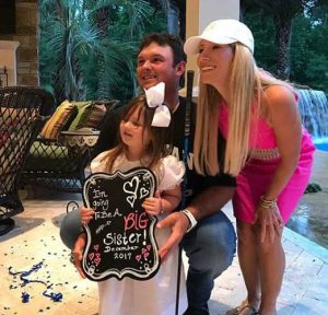 Patrick Reed with his wife, Justine and daughter