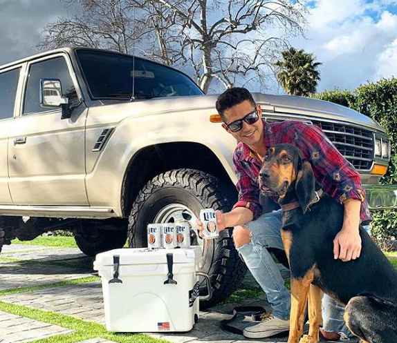 Wells Adams with his car and dog