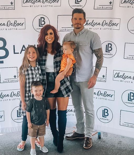 Chelsea Houska with her child and husband