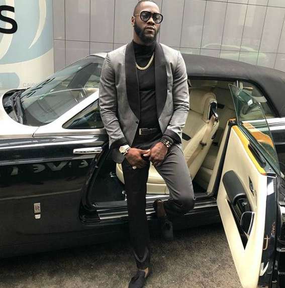 Deontay Wilder posing with his car
