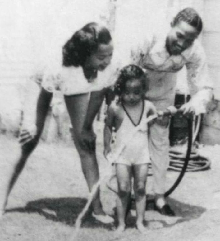 Harolyn Suzanne Nicholas with her late parents in childhood picture