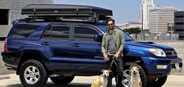 Chris McNally with his car and dogs