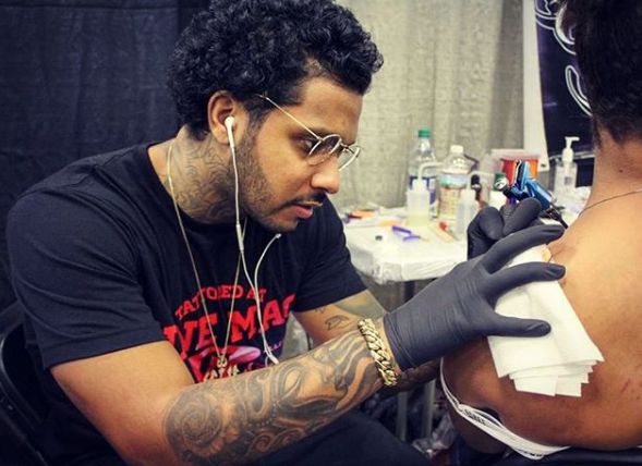 Ryan Henry busy in making tattoos