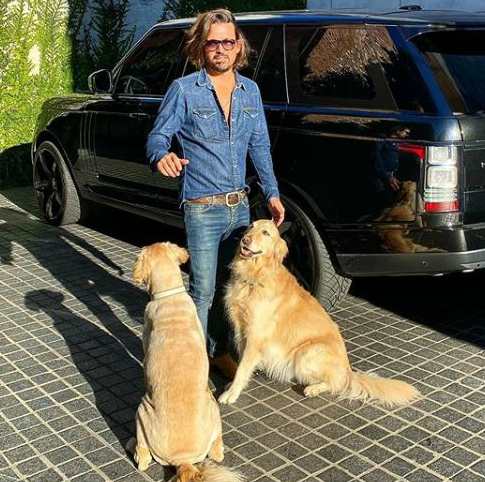Sidney Torres posing with his car