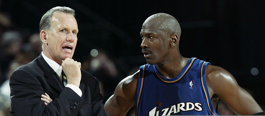 Doug Collins with Michael Jordan talking during the match