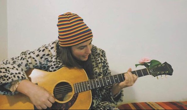 Jade Castrinos playing guitar