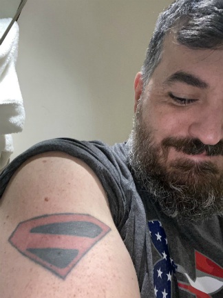 Brian Quinn showing his tattoo