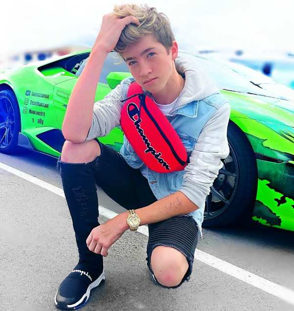 Cash Baker posing with his car