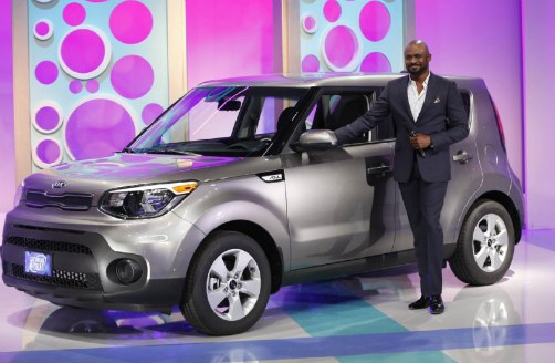 Mandie Taketa's ex-husband, Wayne Brady posing with his car