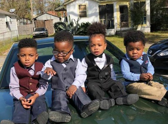 Taylin Gaulden sitting with his siblings