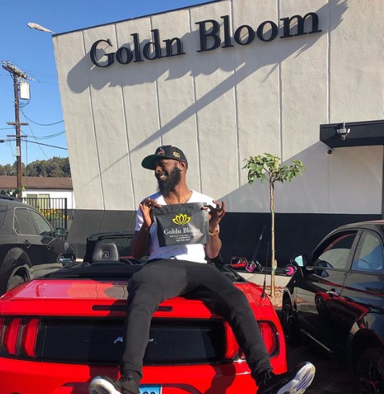 Karlous Miller sitting outside of his car