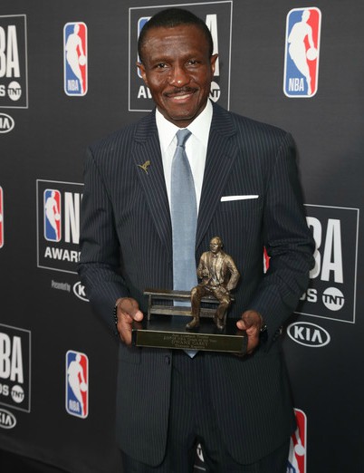 Brenda Casey's husband, Dwane Casey posing with his award