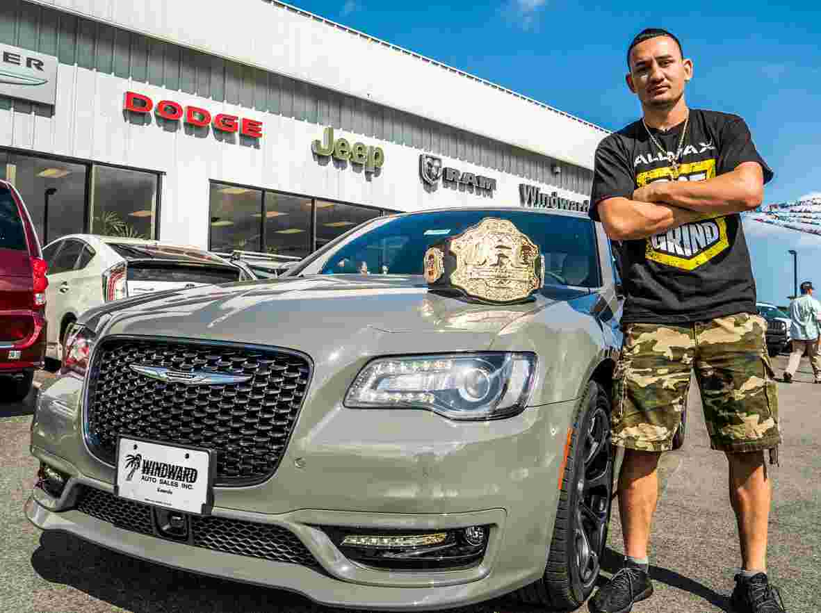 Kaimana Pa'aluhi ex-husband standing outside his car with UFC title