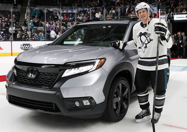 Sidney Crosby standing in front of his car