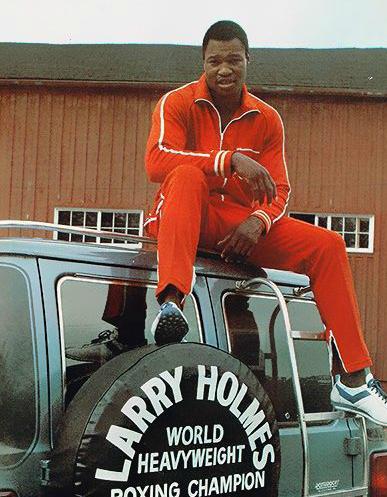 Larry Holmes posing with his vehicle