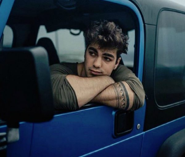 Thomas Petrou sitting in a car