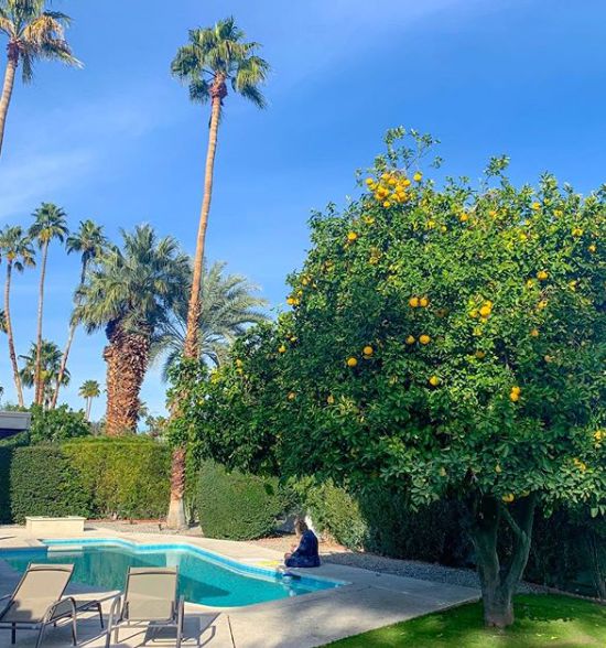 Grace Helbig sitting outside her house