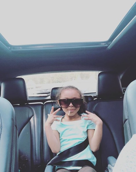 Avielle Janelle Hernandez posing for a picture while sitting inside the car