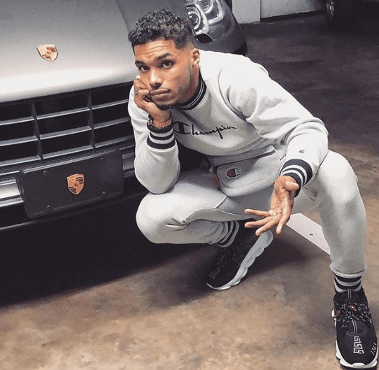 Kimiko Flynn's father Rome posing for photo with the car