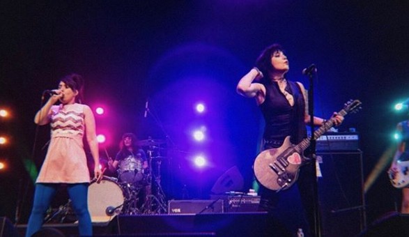 Joan Jett signing song with her band