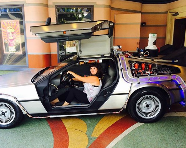 Ellen Hamilton Latzen poses for a photo with her car