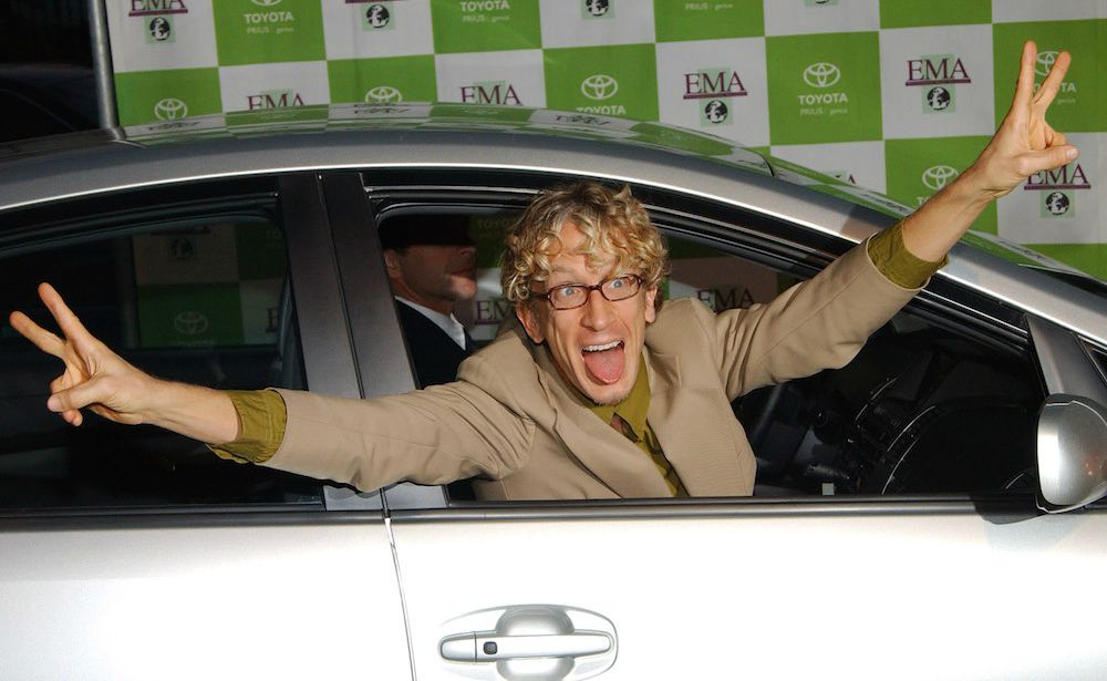 Lena Sved's husband Andy posing for the picture sitting inside his car