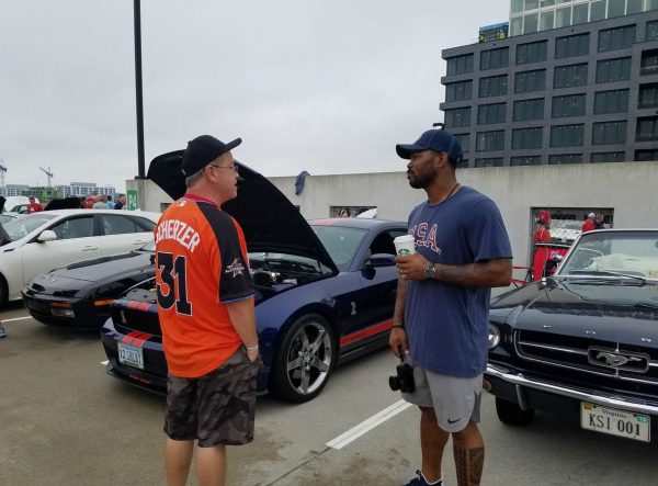 Howie Kendrick talking to his friend while cars in the backgrounds