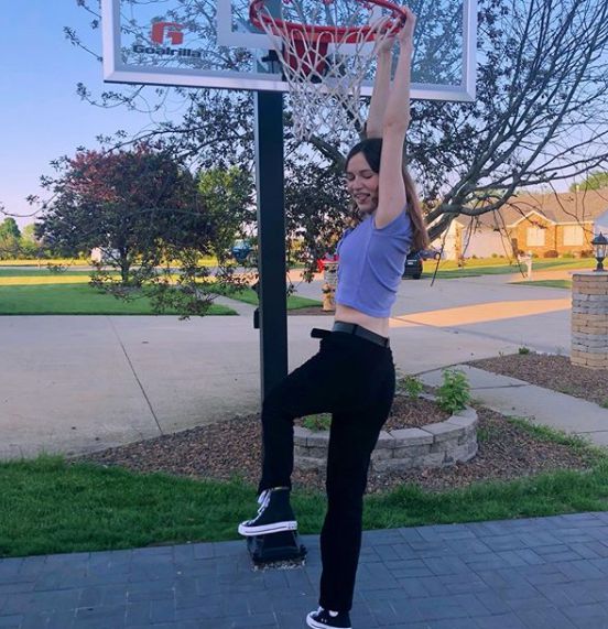 Claire Drake hanging in the basketball pole