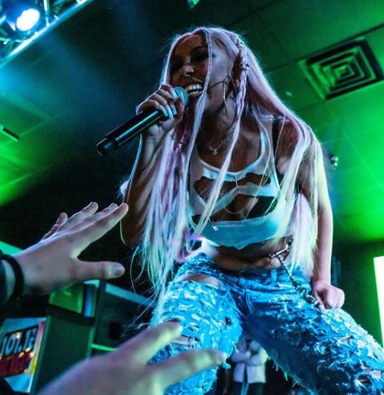 Doja Cat singing songs in the concert
