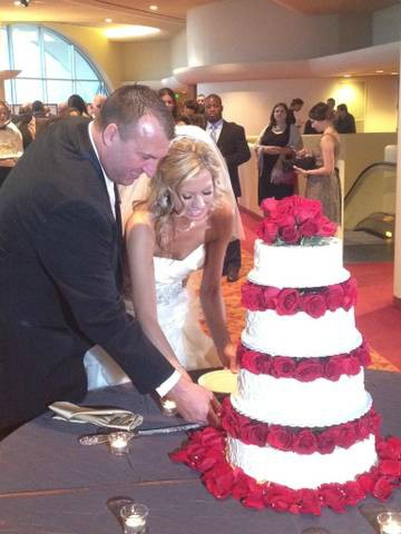Jennifer Hielsberg cutting cake with her husband on their wedding day