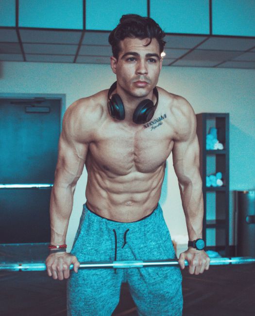 Ray Diaz posing for a picture showing his body