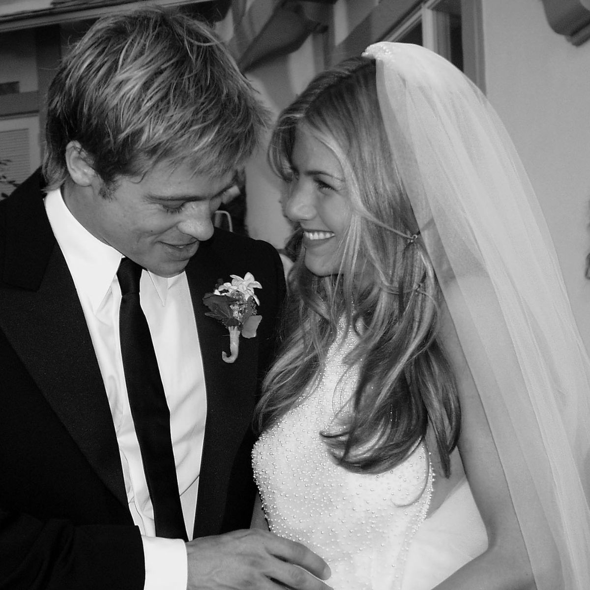 Jennifer Aniston with her ex-husband Brad Pitt in their wedding dress