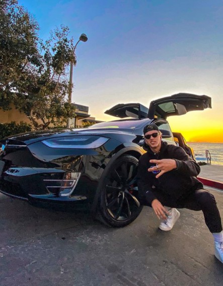 Nate Garner posing for a photo with a classic car