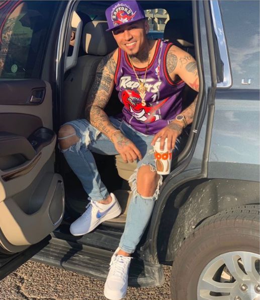 Kirko Bangz posing for a picture sitting in the car