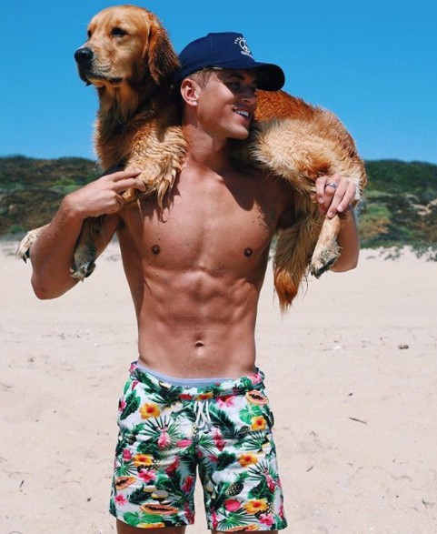 Nate Garner carrying his dog