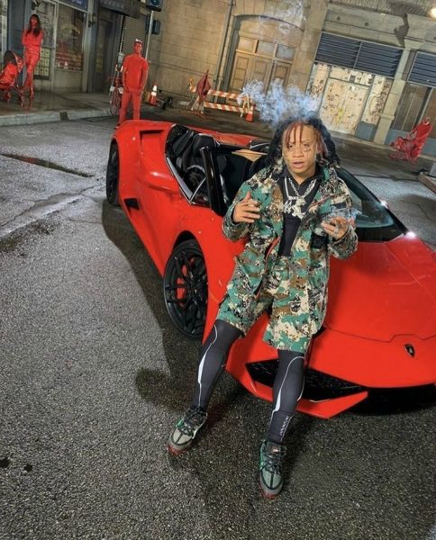 Trippie Redd posing for picture sitting in a car