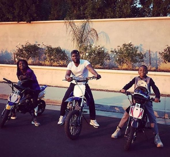 Hendrix Hart sitting in bike along with her father and sibling sister