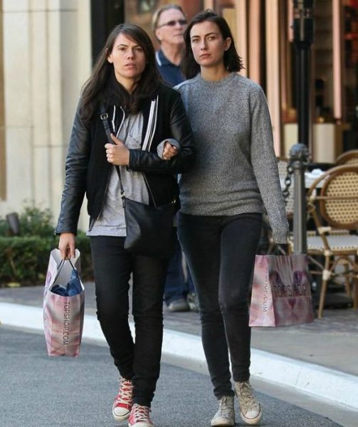 Clea DuVall walking holding hand of her mysterious partner