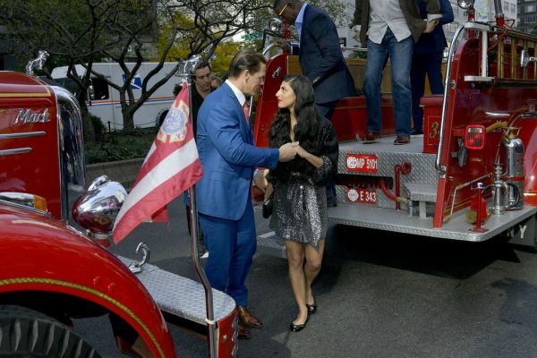 Shay Shariatzadeh with her husband cena with Fire Trucks in the background