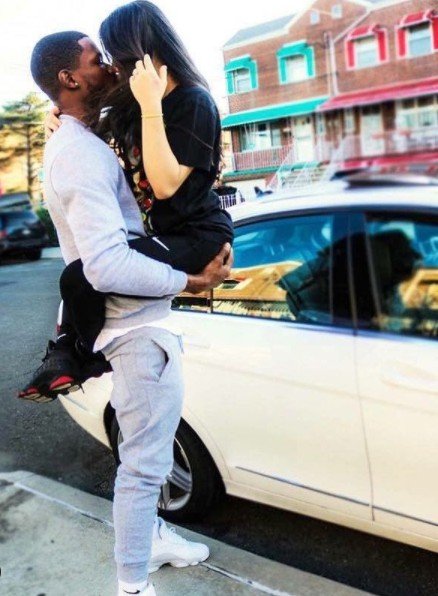 Liana Loyal Family kissing her husband while car in the background