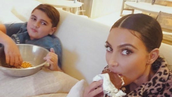 Mason Disick eating food with his aunt Kim