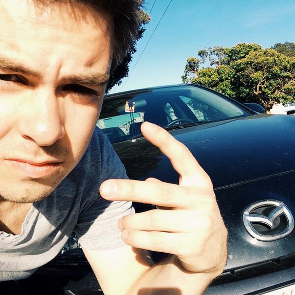 Cody taking picture with his car 