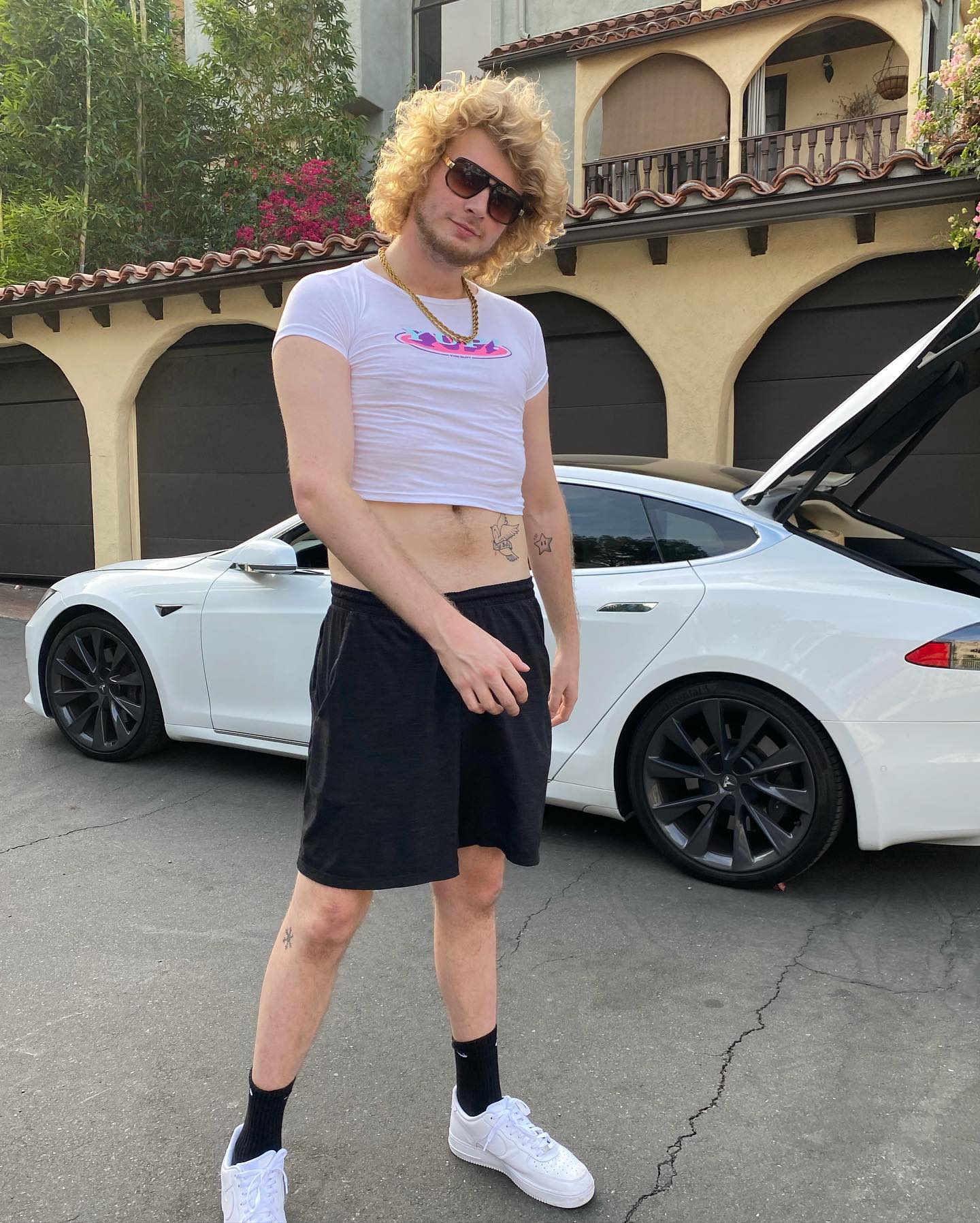 Gravy posing for a photo with his car