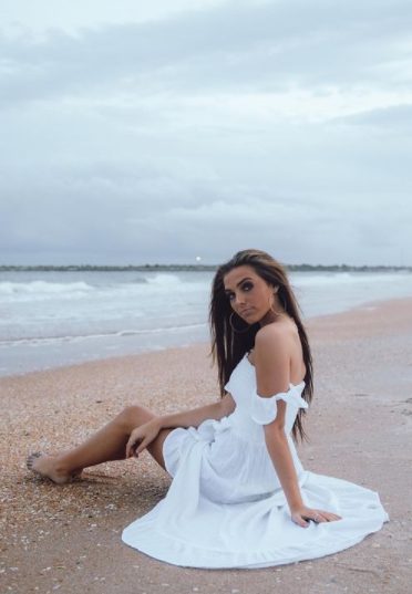 Jordan Beckham sitting in the beach