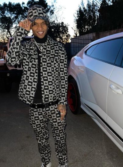 Khalif posing with his car